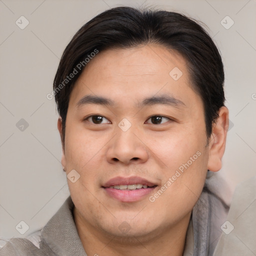 Joyful asian young-adult male with short  brown hair and brown eyes