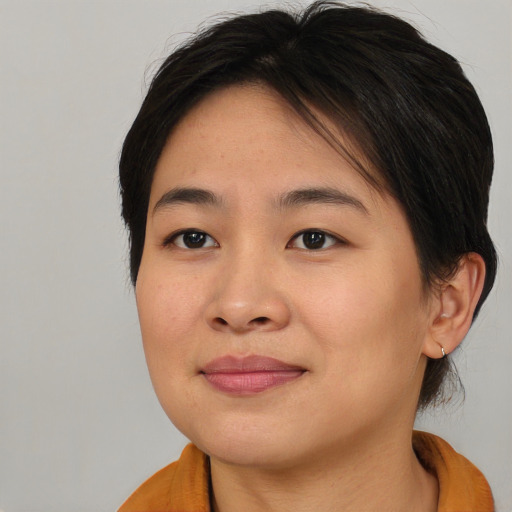 Joyful asian young-adult female with medium  brown hair and brown eyes