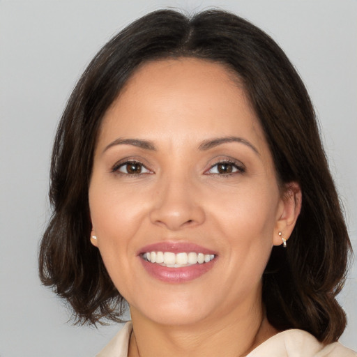 Joyful white adult female with medium  brown hair and brown eyes