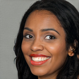 Joyful latino young-adult female with long  black hair and brown eyes