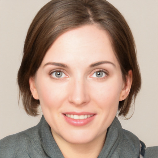 Joyful white young-adult female with medium  brown hair and blue eyes