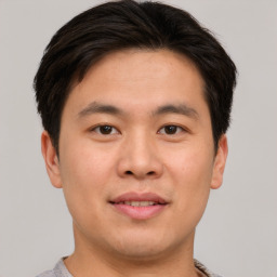 Joyful asian young-adult male with short  brown hair and brown eyes