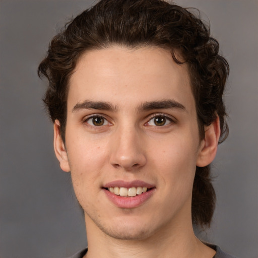 Joyful white young-adult male with medium  brown hair and brown eyes