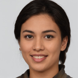 Joyful latino young-adult female with medium  brown hair and brown eyes