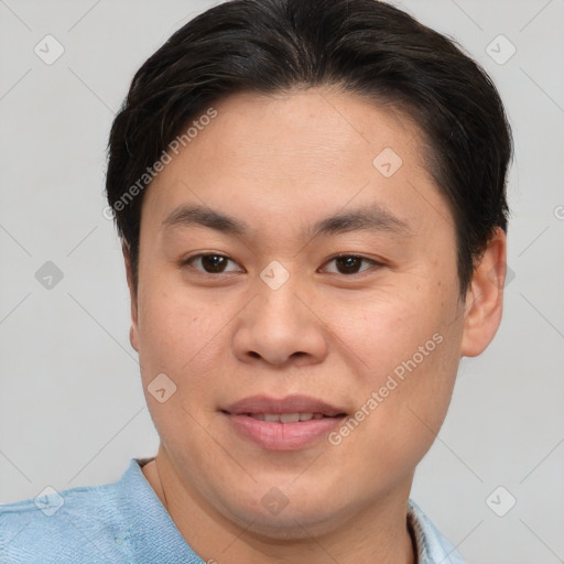 Joyful asian young-adult male with short  brown hair and brown eyes