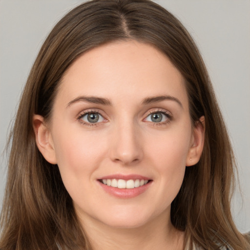 Joyful white young-adult female with long  brown hair and grey eyes