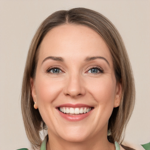 Joyful white young-adult female with medium  brown hair and green eyes