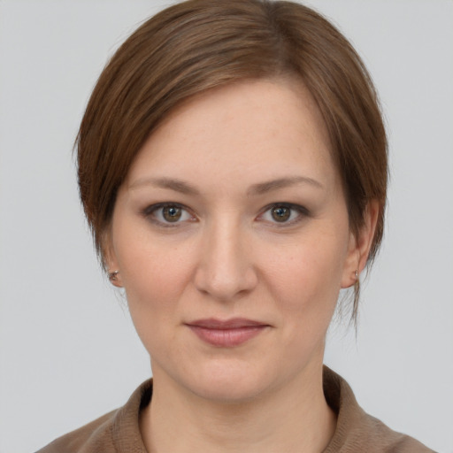 Joyful white young-adult female with medium  brown hair and grey eyes