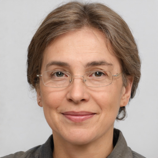 Joyful white middle-aged female with medium  brown hair and grey eyes