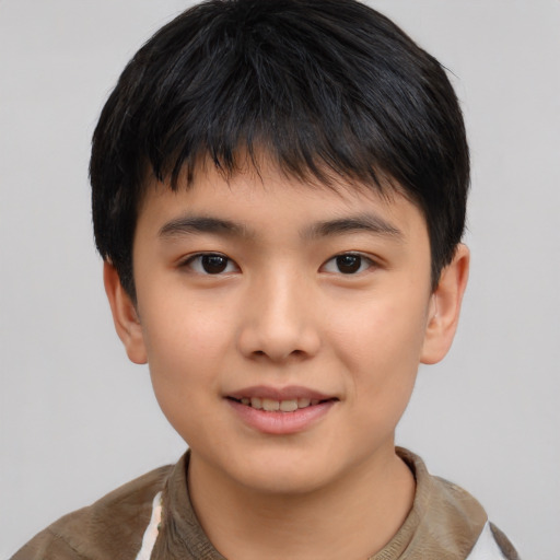 Joyful asian child male with short  brown hair and brown eyes