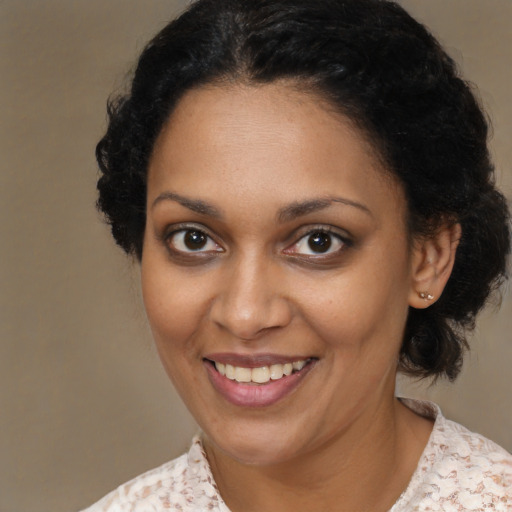 Joyful black young-adult female with medium  brown hair and brown eyes