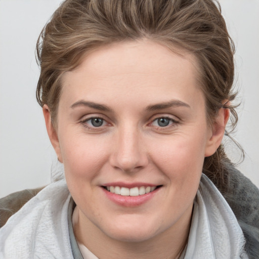 Joyful white young-adult female with medium  brown hair and blue eyes