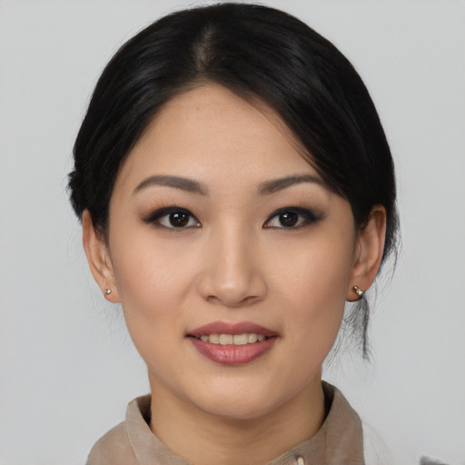 Joyful asian young-adult female with medium  black hair and brown eyes
