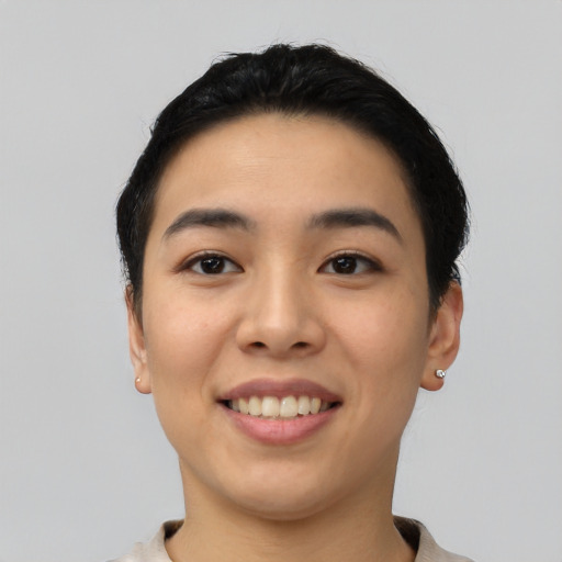 Joyful asian young-adult female with short  black hair and brown eyes