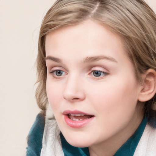 Joyful white child female with medium  brown hair and blue eyes