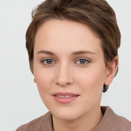 Joyful white young-adult female with short  brown hair and grey eyes