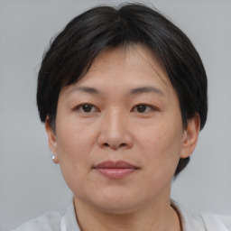 Joyful asian adult female with short  brown hair and brown eyes