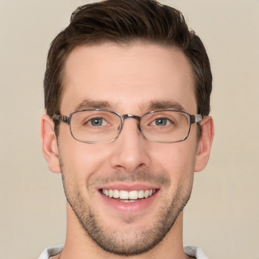 Joyful white young-adult male with short  brown hair and grey eyes