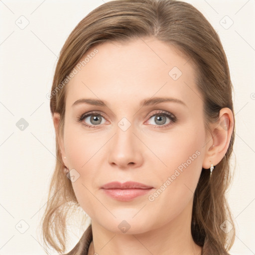 Joyful white young-adult female with long  brown hair and blue eyes