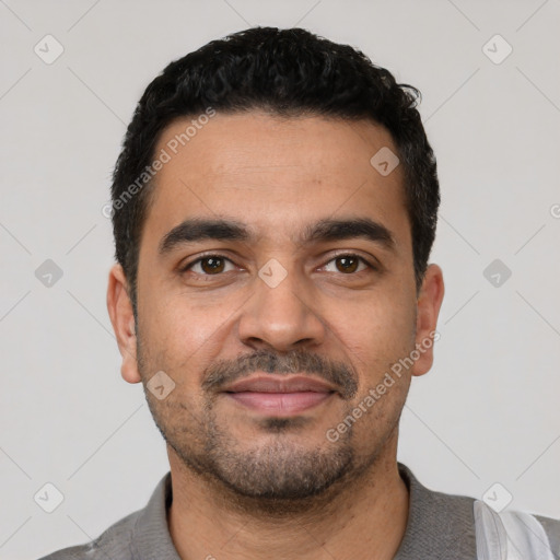 Joyful latino young-adult male with short  black hair and brown eyes