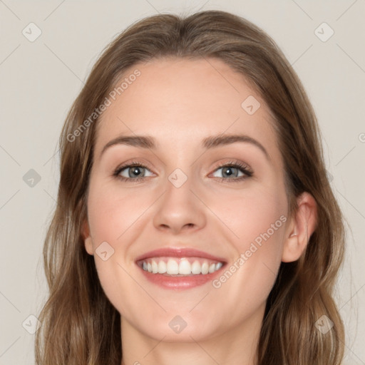 Joyful white young-adult female with long  brown hair and green eyes