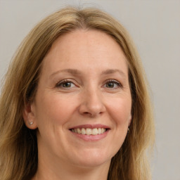 Joyful white adult female with long  brown hair and grey eyes