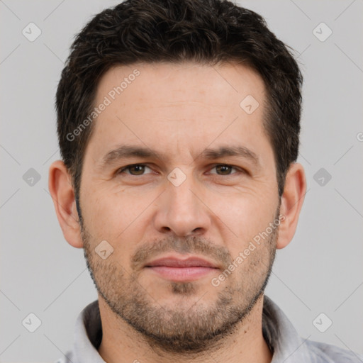 Joyful white adult male with short  brown hair and brown eyes