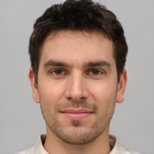 Joyful white young-adult male with short  brown hair and brown eyes