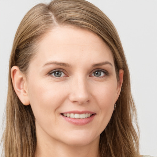 Joyful white young-adult female with long  brown hair and grey eyes