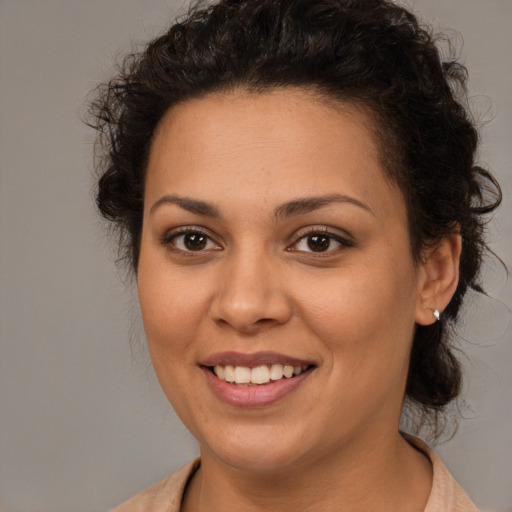 Joyful white young-adult female with medium  brown hair and brown eyes
