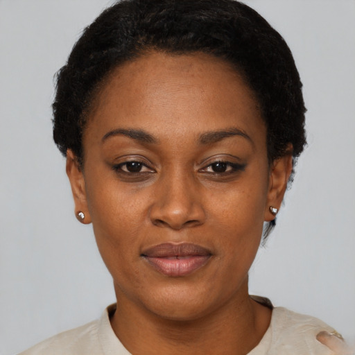 Joyful black adult female with short  black hair and brown eyes