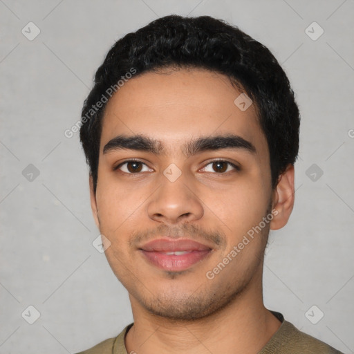 Joyful latino young-adult male with short  black hair and brown eyes