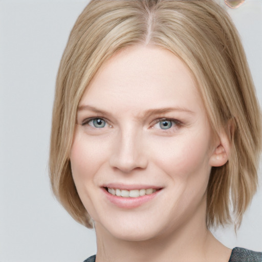 Joyful white young-adult female with medium  brown hair and blue eyes