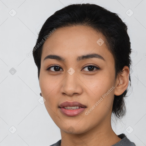 Joyful asian young-adult female with medium  black hair and brown eyes