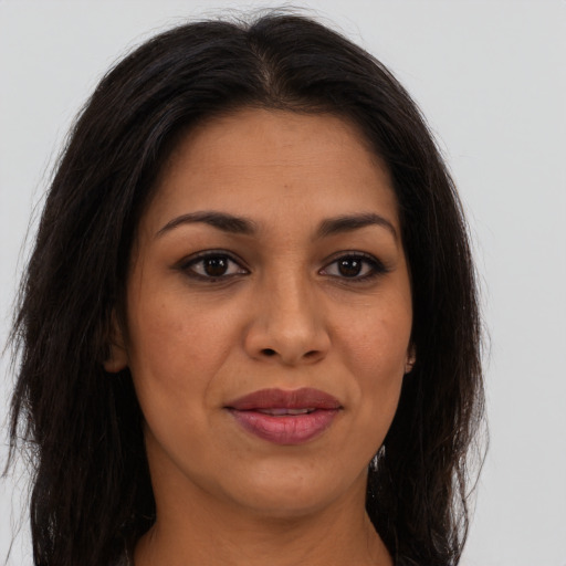 Joyful latino young-adult female with long  brown hair and brown eyes