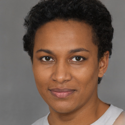 Joyful black young-adult female with short  brown hair and brown eyes