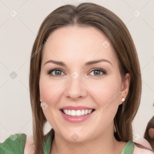 Joyful white young-adult female with medium  brown hair and green eyes