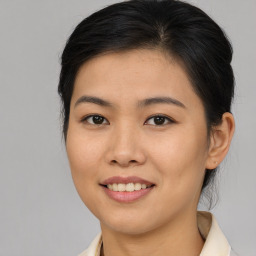 Joyful asian young-adult female with medium  brown hair and brown eyes