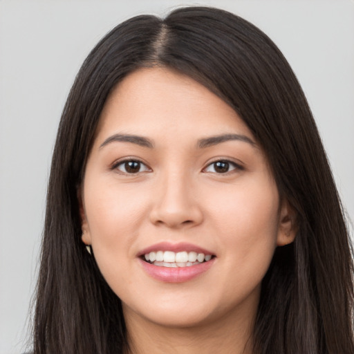 Joyful latino young-adult female with long  brown hair and brown eyes