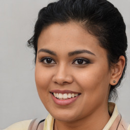 Joyful latino young-adult female with medium  brown hair and brown eyes