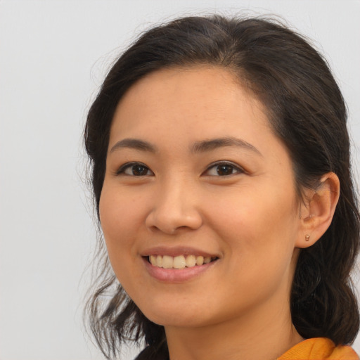 Joyful asian young-adult female with medium  brown hair and brown eyes