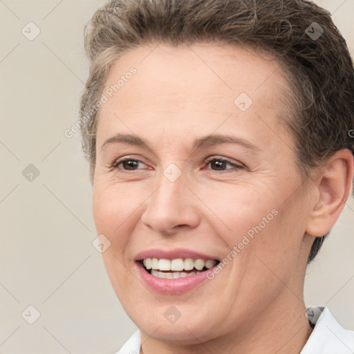 Joyful white adult female with short  brown hair and brown eyes