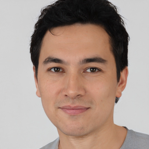 Joyful asian young-adult male with short  black hair and brown eyes
