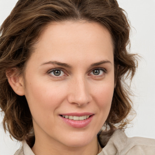 Joyful white young-adult female with medium  brown hair and green eyes