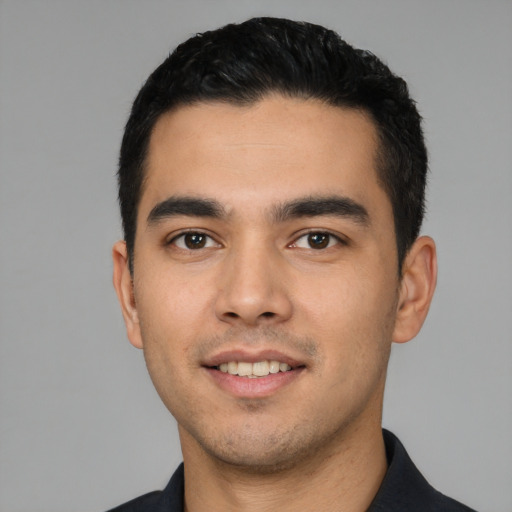 Joyful white young-adult male with short  black hair and brown eyes