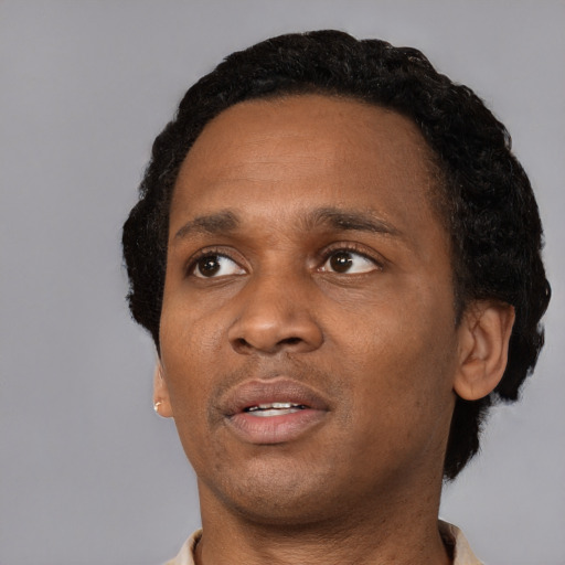 Neutral black adult male with short  black hair and brown eyes