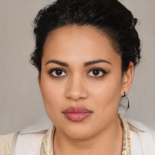 Joyful latino young-adult female with medium  black hair and brown eyes