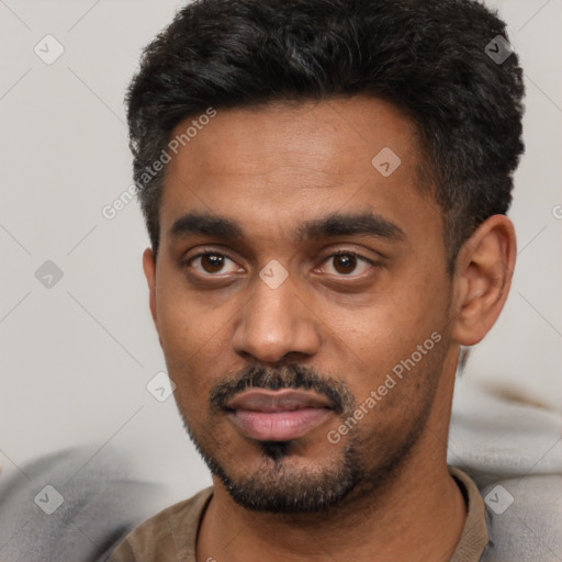 Neutral latino young-adult male with short  black hair and brown eyes