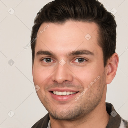 Joyful white young-adult male with short  brown hair and brown eyes