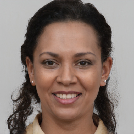 Joyful black adult female with short  brown hair and brown eyes